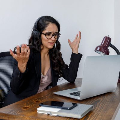 Woman frustrated during an online meeting.